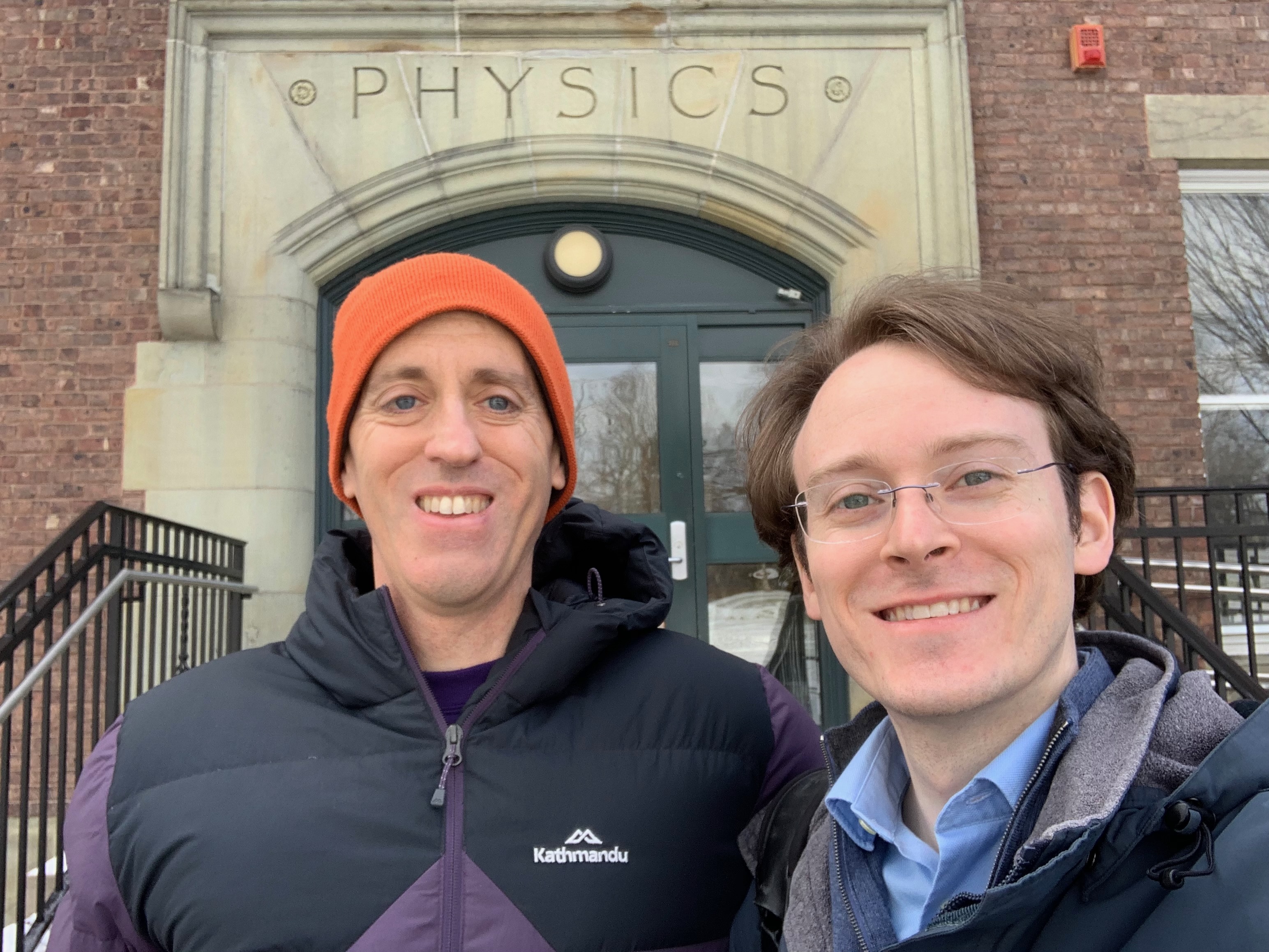Allen and Rob Wittenmyer standing in front of the Physics building at Williams College in winter.