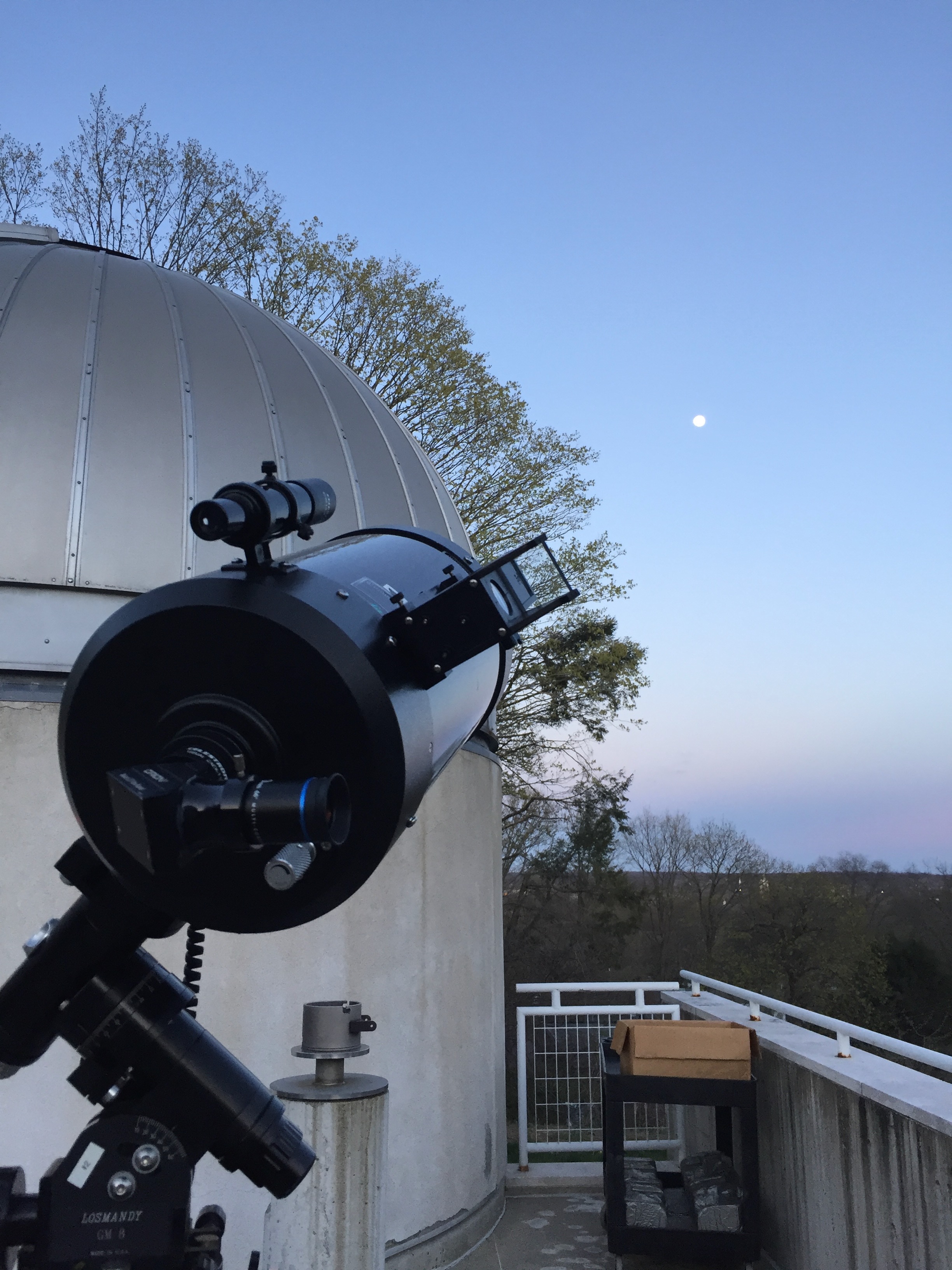 Telescope and dome at the Leitner Family Observatory at Yale, with the moon visible in the twilight sky.