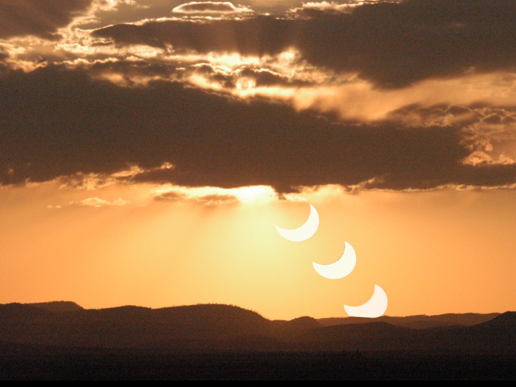 Montage of the eclipsed crescent sun setting over mountains in New Mexico